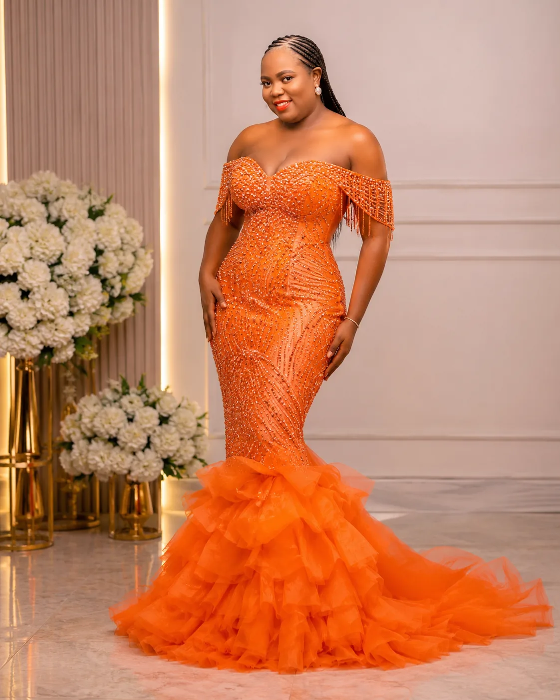 Orange ruffle evening gown in a luxe studio setting