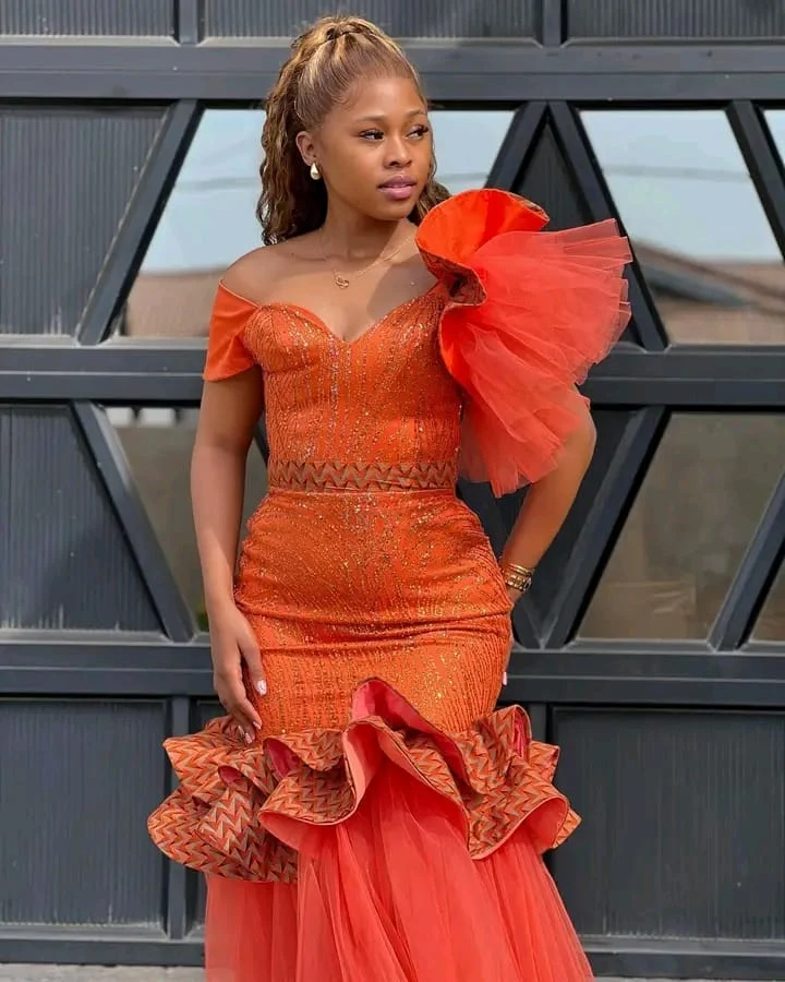 Orange beaded off-shoulder mermaid gown with tulle ruffle